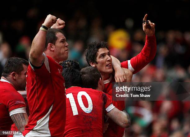 Paul James and James Hook of Wales celebrate the winning try during the RBS 6 Nations match between Wales and Scotland at the Millennium Stadium on...