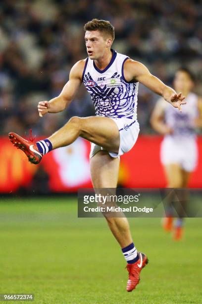 Darcy Tucker of the Dockers kicks the ball during the round 11 AFL match between the Collingwood Magpies and the Fremantle Dockers at Melbourne...
