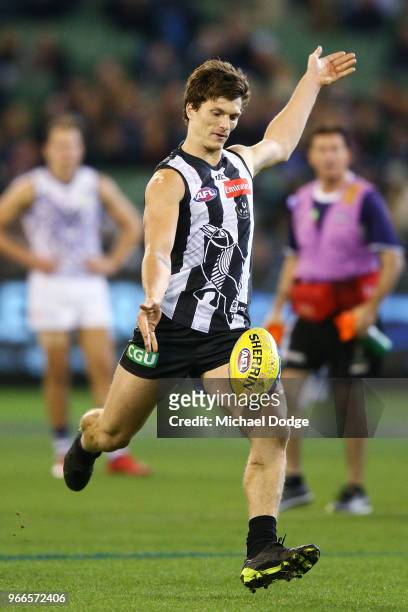 Brody Mihocek of the Magpies kicks the ball for a goal during the round 11 AFL match between the Collingwood Magpies and the Fremantle Dockers at...