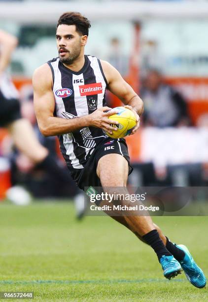 Daniel Wells of the Magpies runs with the ball during the round 11 AFL match between the Collingwood Magpies and the Fremantle Dockers at Melbourne...