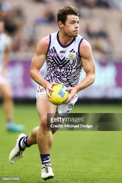 Lachie Neale of the Dockers runs with the ball during the round 11 AFL match between the Collingwood Magpies and the Fremantle Dockers at Melbourne...