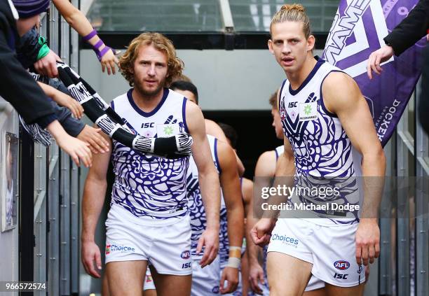 David Mundy and Nat Fyfe of the Dockers leads the team out during the round 11 AFL match between the Collingwood Magpies and the Fremantle Dockers at...