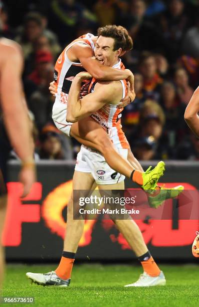 Zac Langdon of the Giants celebrates a goal with Jeremy Cameron of the Giants during the round 11 AFL match between the Adelaide Crows and the...
