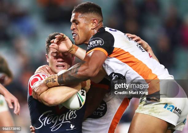 Cooper Cronk of the Roosters is tackled during the round 13 NRL match between the Sydney Roosters and the Wests Tigers at Allianz Stadium on June 3,...