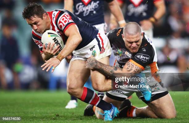 Cooper Cronk of the Roosters is tackled by Russell Packer of the Tigers during the round 13 NRL match between the Sydney Roosters and the Wests...