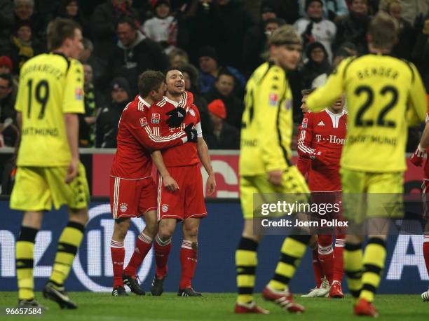 Mark van Bommel of Bayern celebrates with his team mates after scoring his team's first goal during the Bundesliga match between FC Bayern Muenchen...