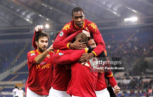 Mirko Vucinic, Juan and Daniele De Rossi of AS Roma celebrate with team mate Matteo Brighi after he scored the opening goal during the Serie A match...