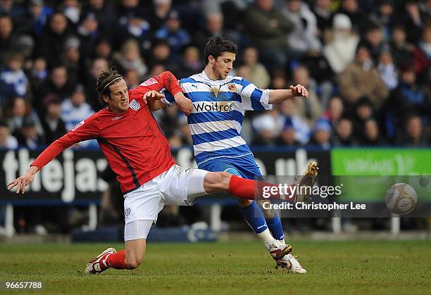 Jonas Olsson of WBA tackles Shane Long of Reading during the FA Cup 5th round match between Reading and West Bromwich Albion at the Madejski Stadium...