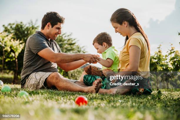 happy parents with their son - dexters stock pictures, royalty-free photos & images