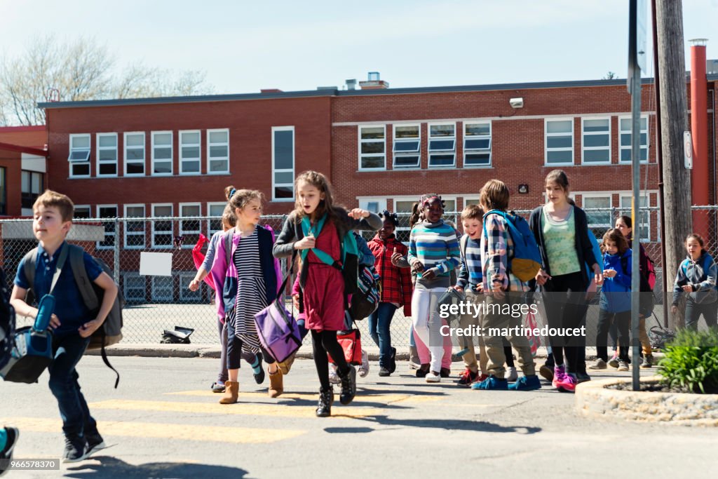 Group Of Multiethnic Kids Crossing Street Getting Out School HighRes