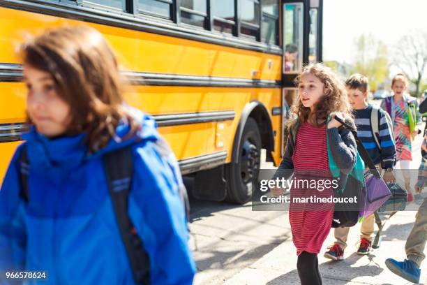 group of kids getting out of school bus. - disembarking stock pictures, royalty-free photos & images