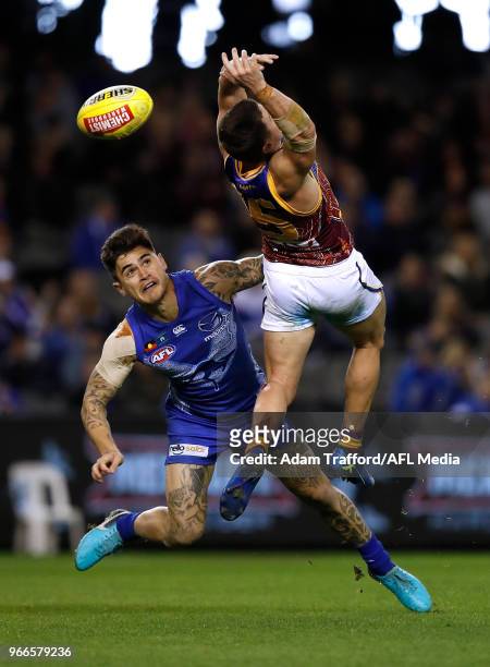 Marley Williams of the Kangaroos and Dayne Zorko of the Lions compete for the ball during the 2018 AFL round 11 match between the North Melbourne...