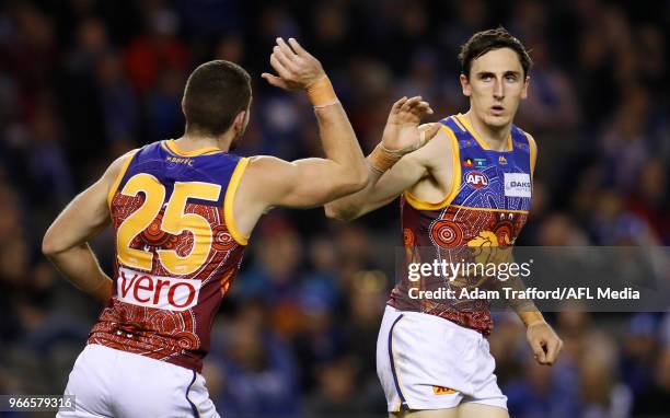 Oscar McInerney of the Lions celebrates a goal with Daniel McStay of the Lions during the 2018 AFL round 11 match between the North Melbourne...