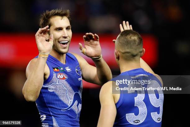 Jamie Macmillan of the Kangaroos congratulates Billy Hartung of the Kangaroos on a goal during the 2018 AFL round 11 match between the North...