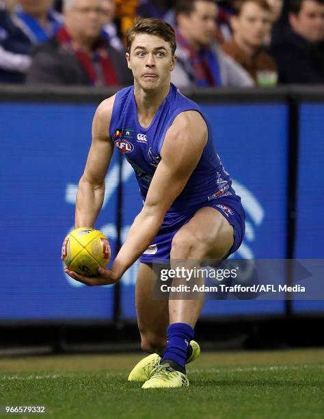Debutant, Tom Murphy of the Kangaroos handpasses the ball during the 2018 AFL round 11 match between the North Melbourne Kangaroos and the Brisbane...