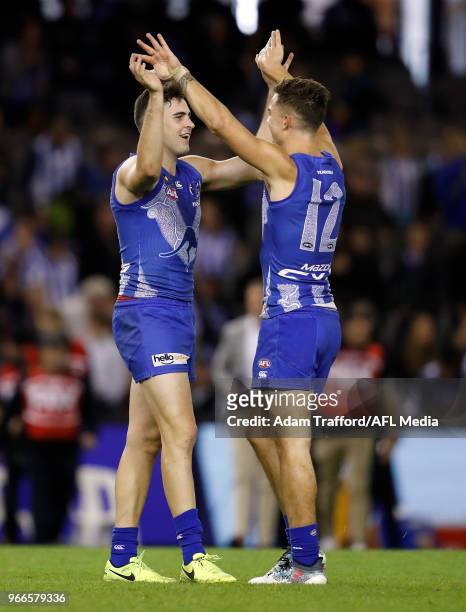 Debutant, Paul Ahern of the Kangaroos celebrates on the final siren with Jy Simpkin of the Kangaroos during the 2018 AFL round 11 match between the...