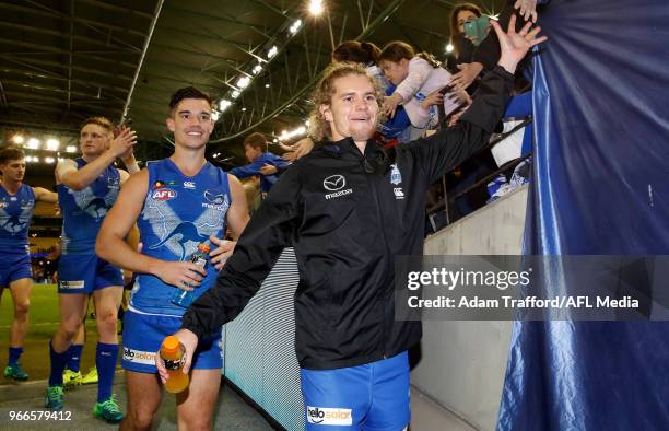 An injured Jed Anderson of the Kangaroos and Jy Simpkin of the Kangaroos thank fans during the 2018 AFL round 11 match between the North Melbourne...