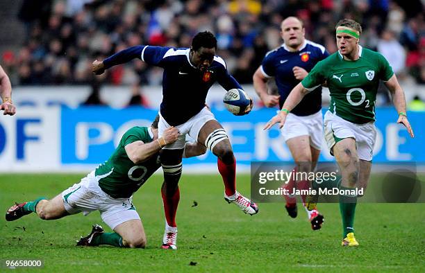 Fulgence Ouedraogo of France is tackled by Ronan O'Gara of Ireland during the RBS Six Nations match between France and Ireland at Stade France on...