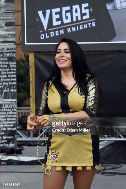 Member of the Vegas Golden Knights Golden Aces throws prizes to the crowd during a Golden Knights road game watch party for Game Three of the 2018...