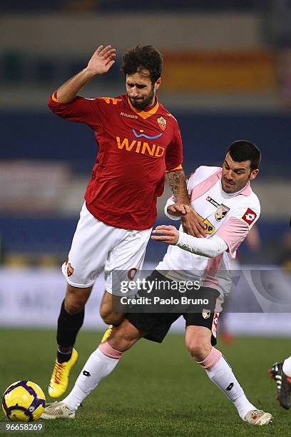 Mirko Vucinic of AS Roma and Cesare Bovo of US Citta' di Palermo in action during the Serie A match between AS Roma and US Citta di Palermo at Stadio...