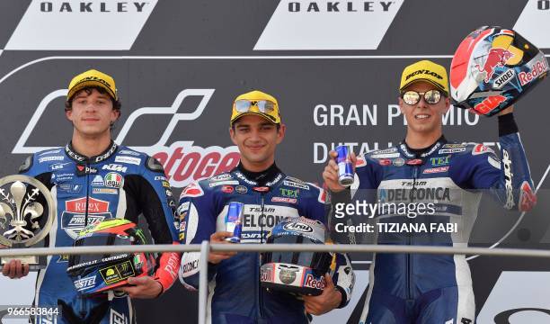 Second placed Redox PrustelGP Italian rider Marco Bezzecchi, first placed Del Conca Gresini Moto3 team Spanish rider Jorge Martin, and third placed...