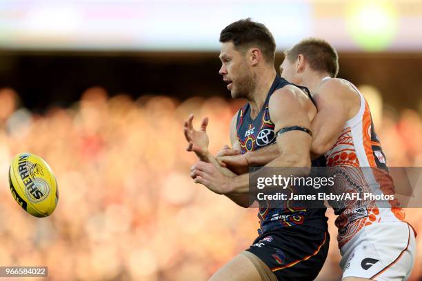 Sam Gibson of the Crows is tackled by Josh Kelly of the Giants during the 2018 AFL round 11 match between the Adelaide Crows and the GWS Giants at...