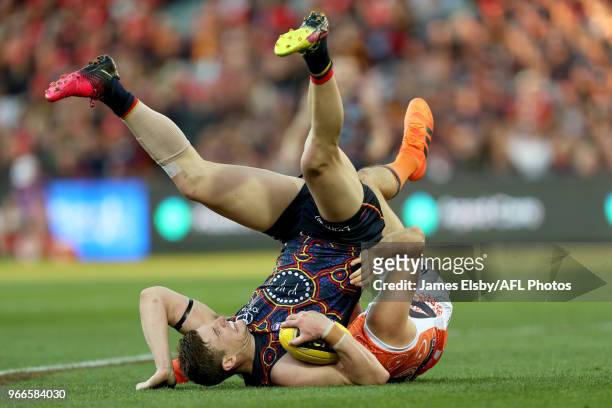 Josh Jenkins of the Crows marks in front of Phil Davis of the Giants during the 2018 AFL round 11 match between the Adelaide Crows and the GWS Giants...