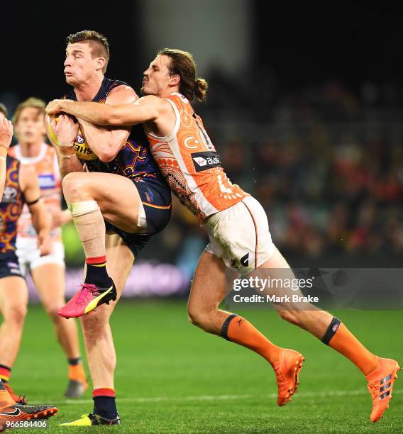 Josh Jenkins of the Adelaide Crows marks in front of Phil Davis of the Giants during the round 11 AFL match between the Adelaide Crows and the...