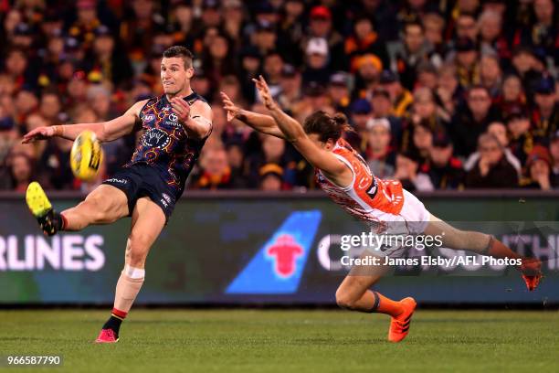 Josh Jenkins of the Crows is tackled by Phil Davis of the Giants during the 2018 AFL round 11 match between the Adelaide Crows and the GWS Giants at...