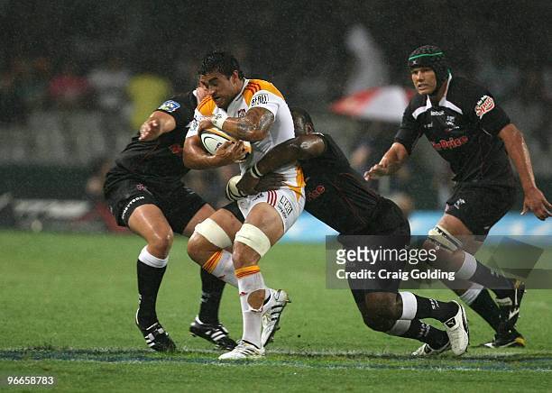 Liam Messam of the Chiefs is tackled by Tendai Mtawarira during the Super 14 match between The Sharks and Chiefs from Absa Stadium on February 13,...
