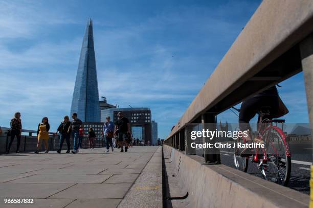 Pedestrains walk over London Bridge next to a roadside barrier put in place after the terror attack on the first anniversary of the London Bridge...