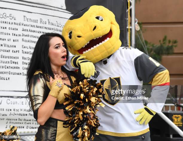 Member of the Vegas Golden Knights Golden Aces and mascot Chance the Golden Gila Monster joke around during a Golden Knights road game watch party...