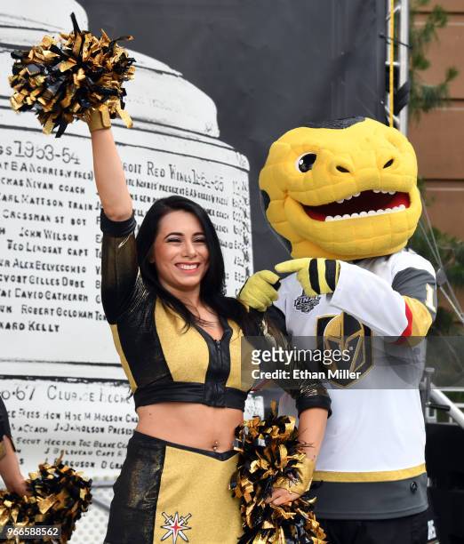 Member of the Vegas Golden Knights Golden Aces and mascot Chance the Golden Gila Monster joke around during a Golden Knights road game watch party...