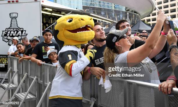 Vegas Golden Knights mascot Chance the Golden Gila Monster poses for photos with fans during a Golden Knights road game watch party for Game Three of...