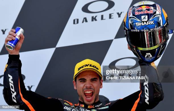 Red Bull KTM Ajo Moto 2 team Portugal's rider Miguel Oliveira celebrates on the podium after winning the Italian Grand Prix of Moto 2 at the Mugello...