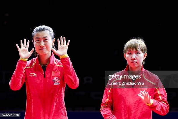 Ding Ning and Zhu Yuling of China attend the award ceremony at the women's doubles final compete with Jeon Jihee and Yang Haeun of South Korea during...