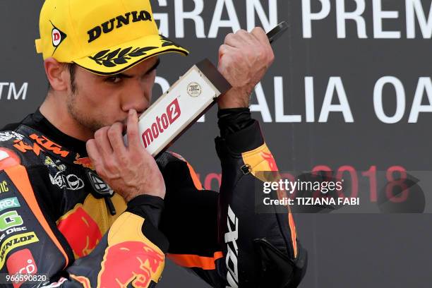 Red Bull KTM Ajo Moto 2 team Portugal's rider Miguel Oliveira celebrates with the trophy on the podium after winning the Italian Grand Prix of Moto 2...