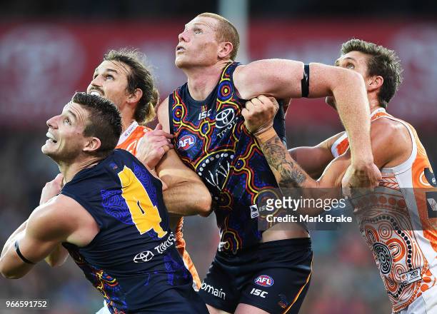 Josh Jenkins and Sam Jacobs of the Adelaide Crows competes and Rory Lobb and Phil Davis of the Giants with during the round 11 AFL match between the...