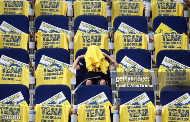 Fan puts on a t-shirt prior to the DKB HBL match between Rhein-Neckar Loewen and DHfK Leipzig at SAP Arena on June 3, 2018 in Mannheim, Germany.