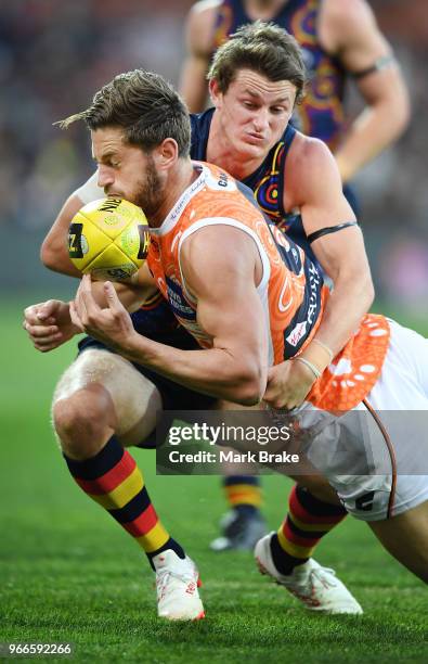 Matt Crouch of the Adelaide Crows tackles Callan Ward of the Giants during the round 11 AFL match between the Adelaide Crows and the Greater Western...