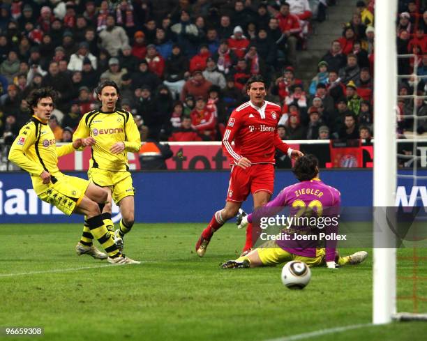 Mario Gomez of Bayern scores his team's third goal during the Bundesliga match between FC Bayern Muenchen and Borussia Dortmund at Allianz Arena on...