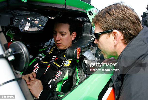 Kyle Busch, driver of the Interstate Batteries Toyota, sits in his car as he talks to crew chief Jason Ratcliff on the grid prior to the NASCAR...