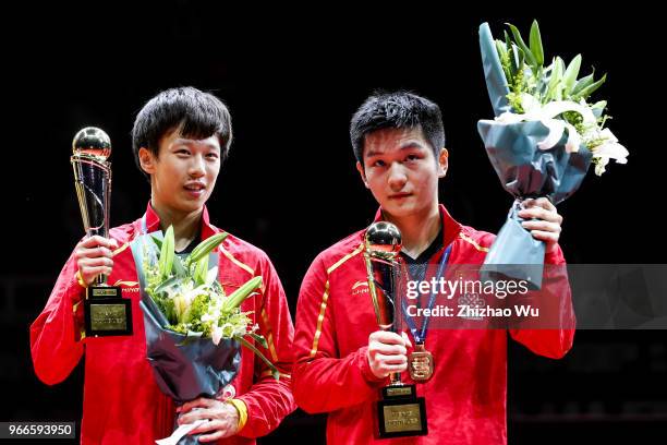 Fan Zhendong and Lin Gaoyuan of China attend the award ceremony at the men's doubles final compete with Ionescu Ovidiu of Romania and Robles Alvaro...