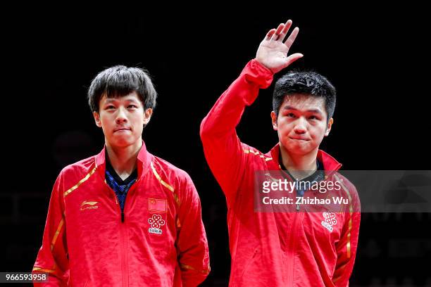 Fan Zhendong and Lin Gaoyuan of China attend the award ceremony at the men's doubles final compete with Ionescu Ovidiu of Romania and Robles Alvaro...