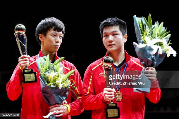 Fan Zhendong and Lin Gaoyuan of China attend the award ceremony at the men's doubles final compete with Ionescu Ovidiu of Romania and Robles Alvaro...