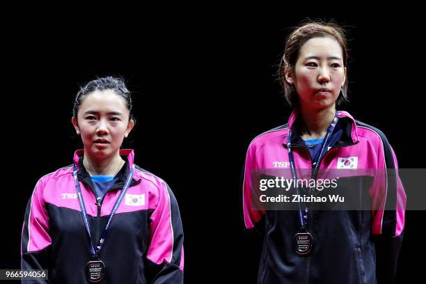 Jeon Jihee and Yang Haeun of South Korea attend the award ceremony at the women's doubles final compete with Ding Ning and Zhu Yuling of China during...