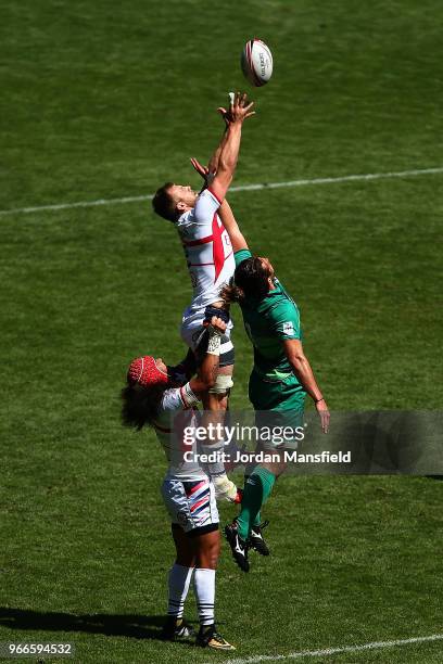 Ben Pinkelman of the USA and Harry McNulty of Ireland compete for a ball in the air on day two of the HSBC London Sevens at Twickenham Stadium on...