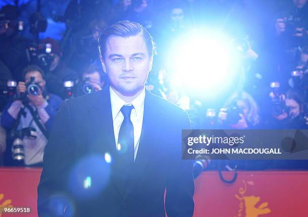 Actor Leonardo Di Caprio pose for photographers as he arrives on the red carpet at the premiere of the film "Shutter Island" during the 60th...