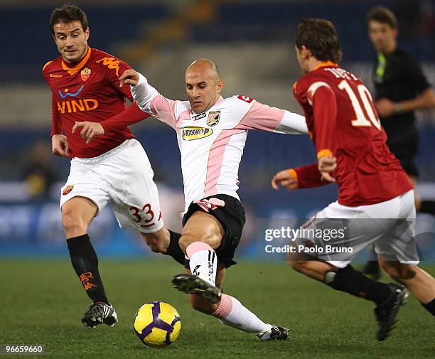 Matteo Brighi and Francesco Totti of AS Roma and Mark Bresciano of US Citta' di Palermo compete for the ball during the Serie A match between AS Roma...