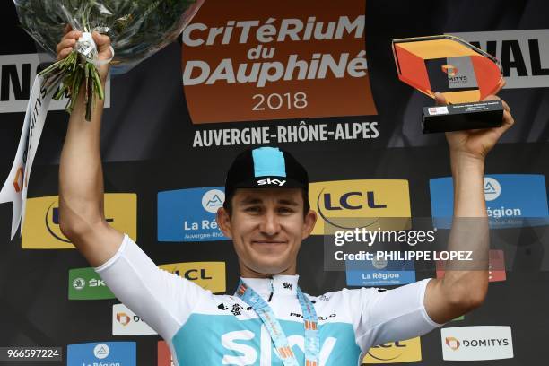 Stage winner Poland's Michal Kwiatkowski celebrates on the podium after winning the rides during a 6,6 km individual time-trial, the prologue of the...